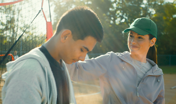 Young coach encouraging their player