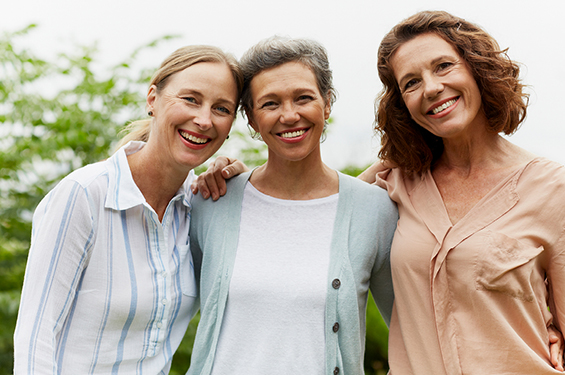 Three women hugging and smiling